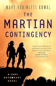 The Martian Contingency cover is mostly yellow/gold with shades of orange red on the left side. At the bottom right corner there is a black image two  people in space suites standing on a cliff overlooking a base in the distance on the bottom right. The title of the book is in the center with the authors name above it. 